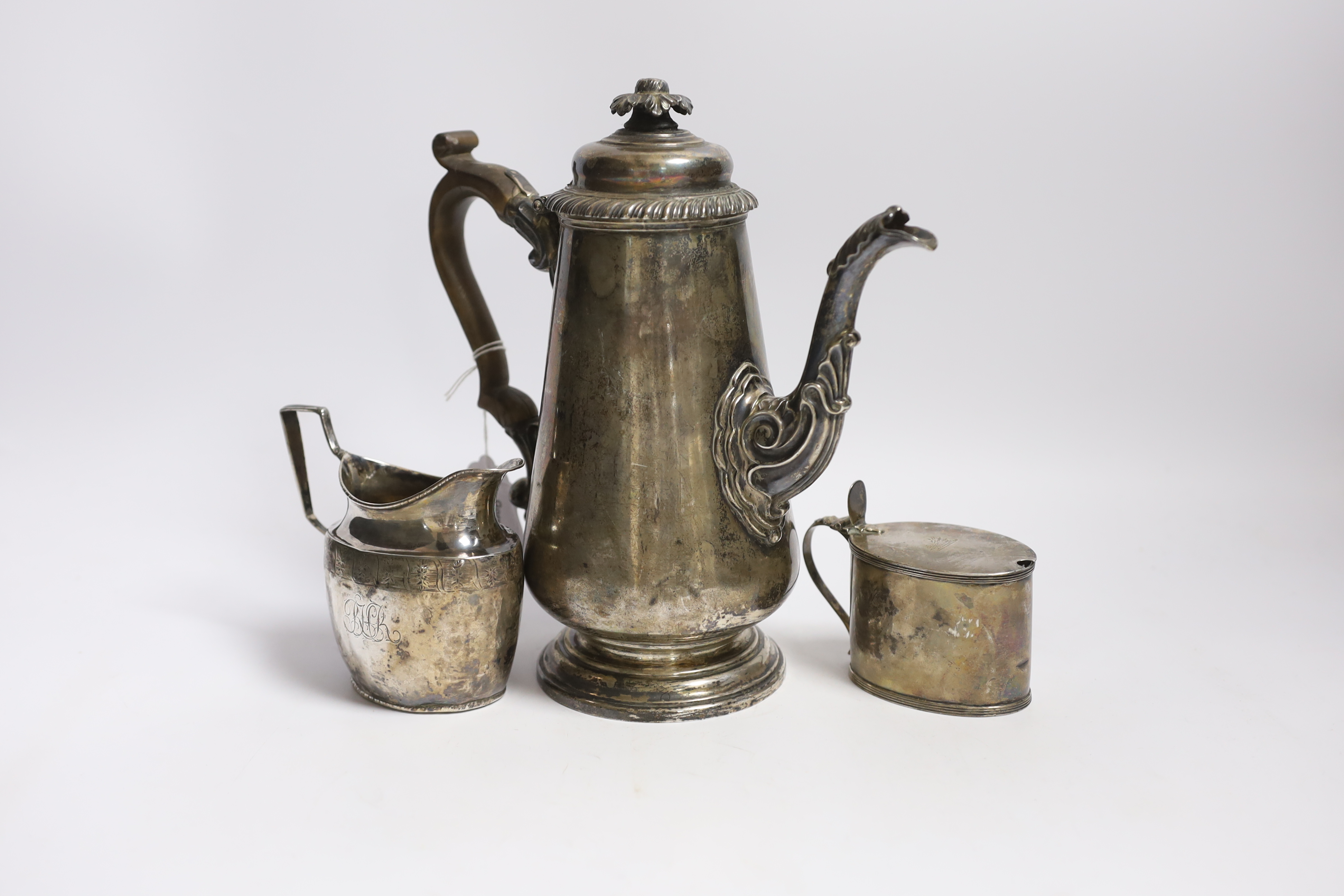 A George IV silver coffee pot, by S.C. Younge & Co, Sheffield, 1821, height 24.5cm, together with a Georgian silver cream jug (a.f.) and a George III silver oval mustard pot by Peter & Ann Bateman, London, 1799, gross we